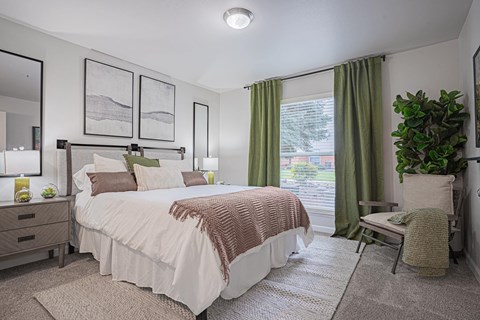 a bedroom with a large bed and a window at Austin Crest Apartments, Reno, 89523